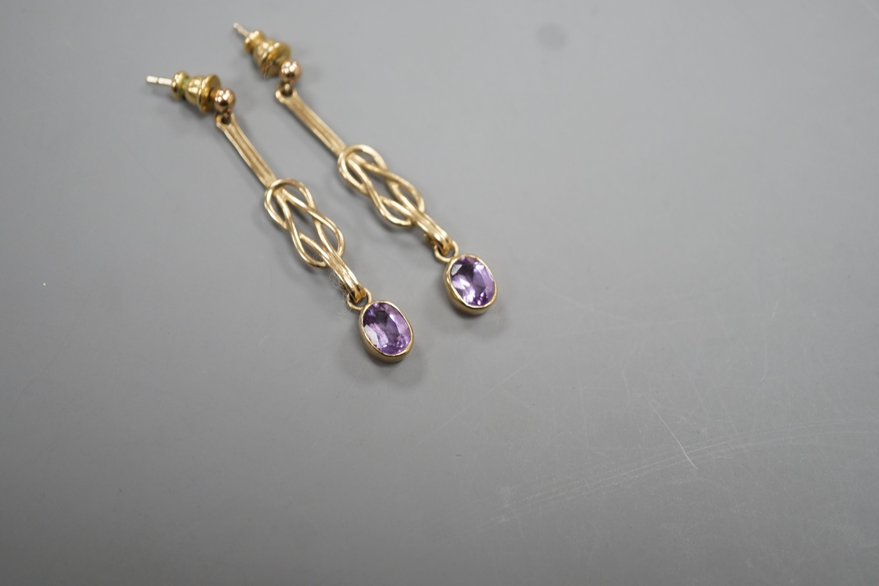 A modern pair of 9ct gold and amethyst set drop earrings, 4cm, gross 3.8 grams.